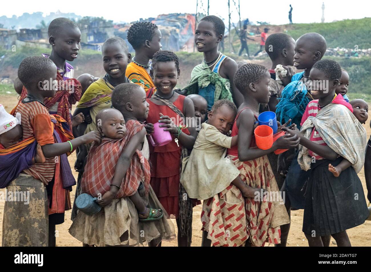 Older children from Kisenyi, an area of Kampala, Uganda, care for and carry younger siblings. Stock Photo
