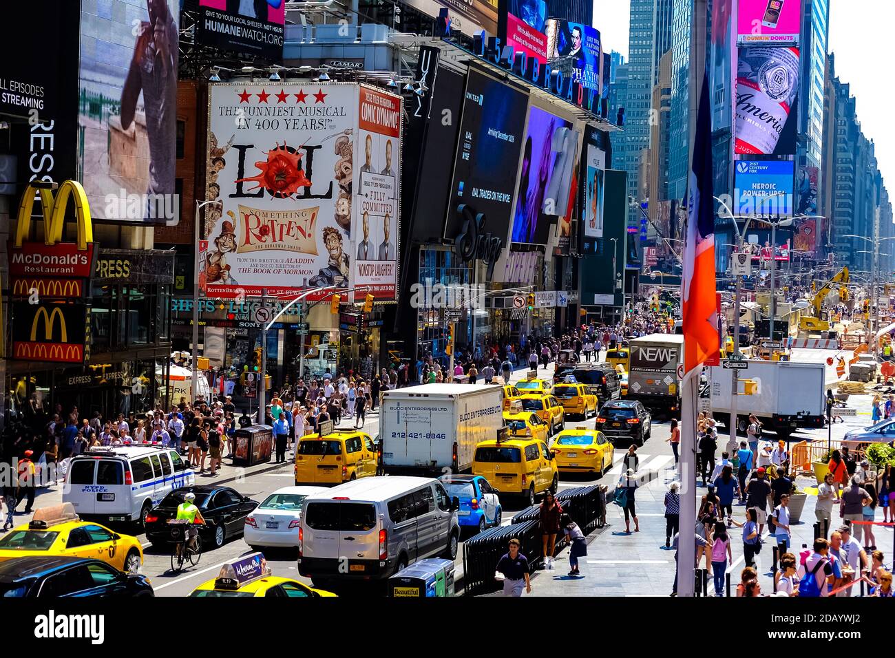 Times Square with yellow New York City Taxi cabs and tour buses driving