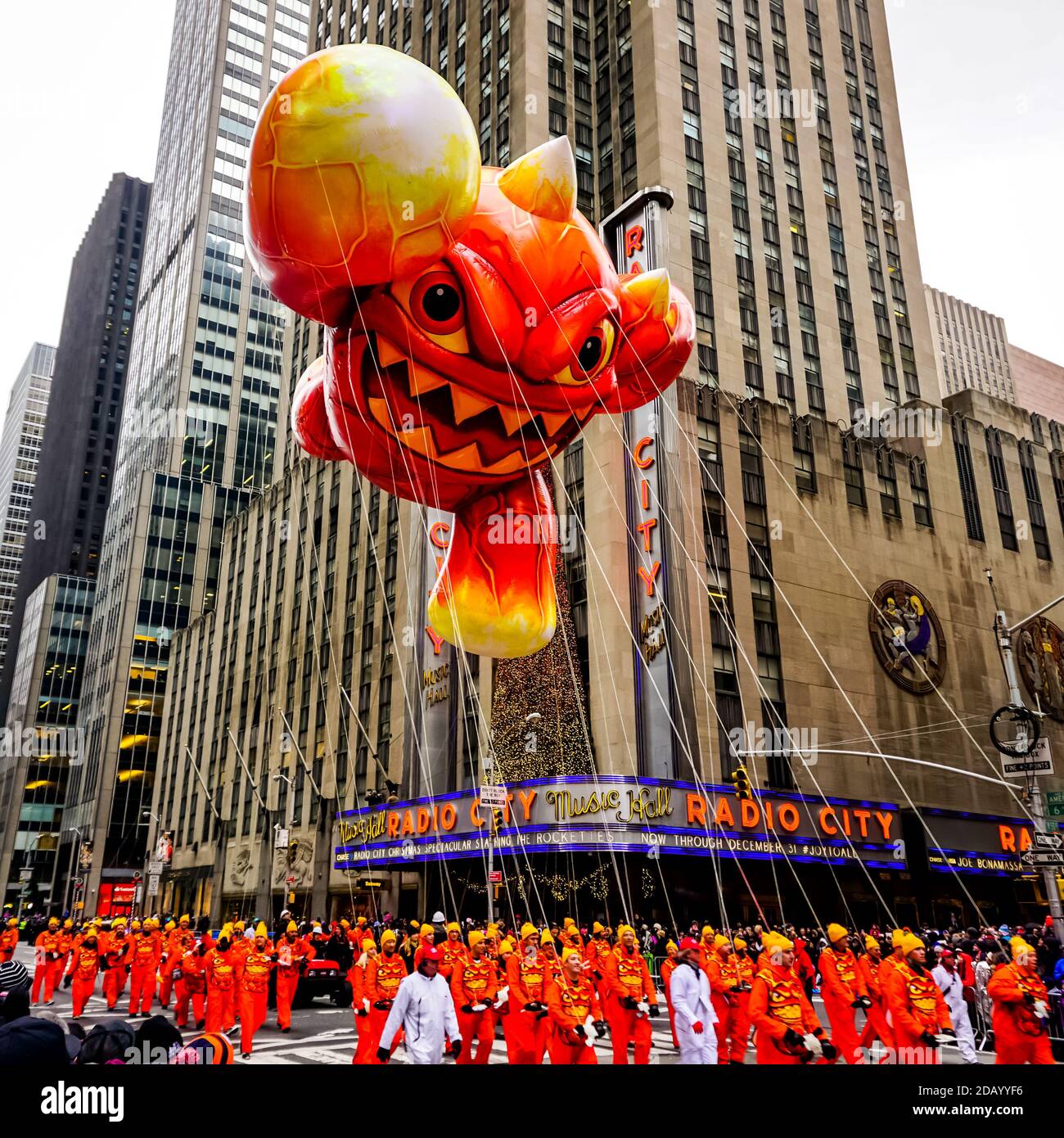 Skylander Eruptor balloon floats in the air during Macy's Thanksgiving Day parade along Avenue of Americas with the Radio Music Hall in the background Stock Photo