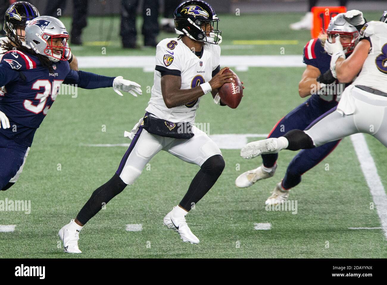 Foxborough, United States. 15th Nov, 2020. Baltimore Ravens quarterback Lamar Jackson (8) scrambles with the ball in the first quarter against the New England Patriots at Gillette Stadium in Foxborough, Massachusetts on Sunday, November 15, 2020. Photo by Matthew Healey/UPI Credit: UPI/Alamy Live News Stock Photo