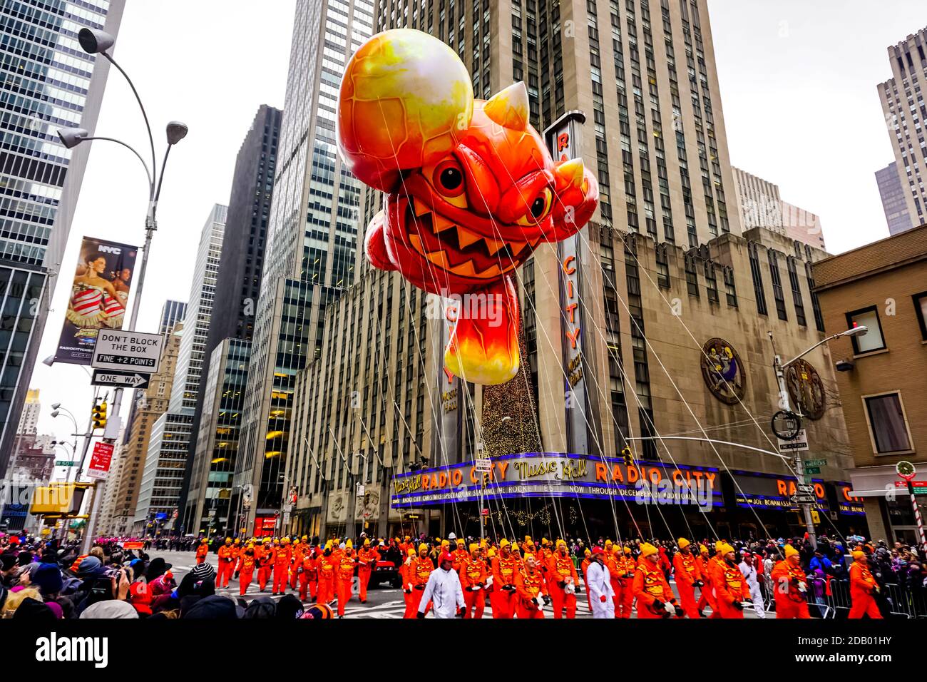 Skylander Eruptor balloon floats in the air during Macy's Thanksgiving Day parade along Avenue of Americas with the Radio Music Hall in the background Stock Photo