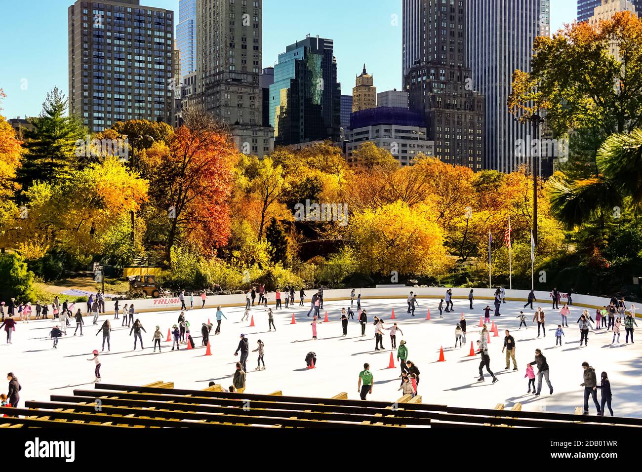 People ice skating at the Wollman Rink in Central Park on a sunny