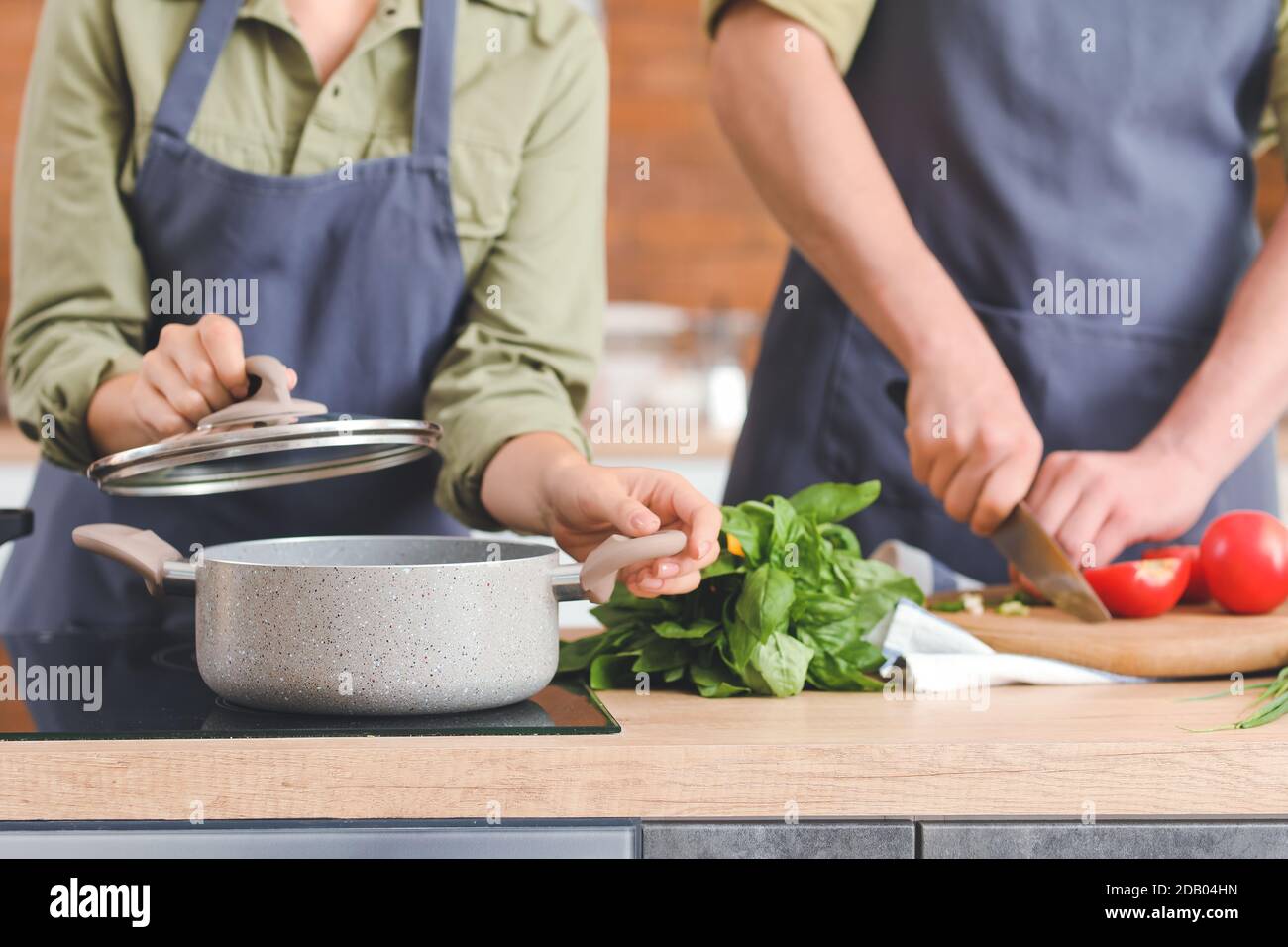 Young couple cooking dinner in kitchen Stock Photo