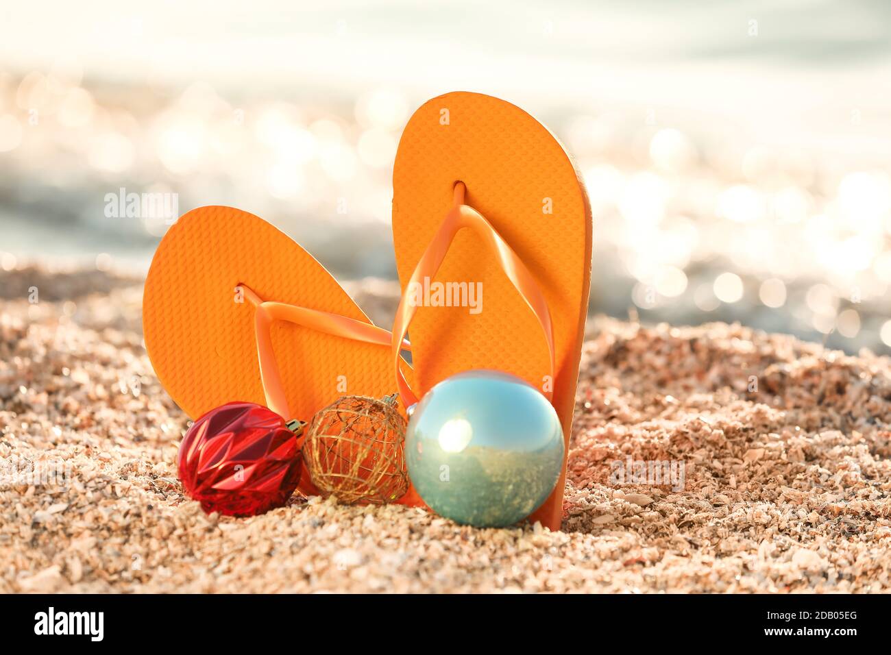 Flip-flops and decor on sea beach. Christmas vacation concept Stock