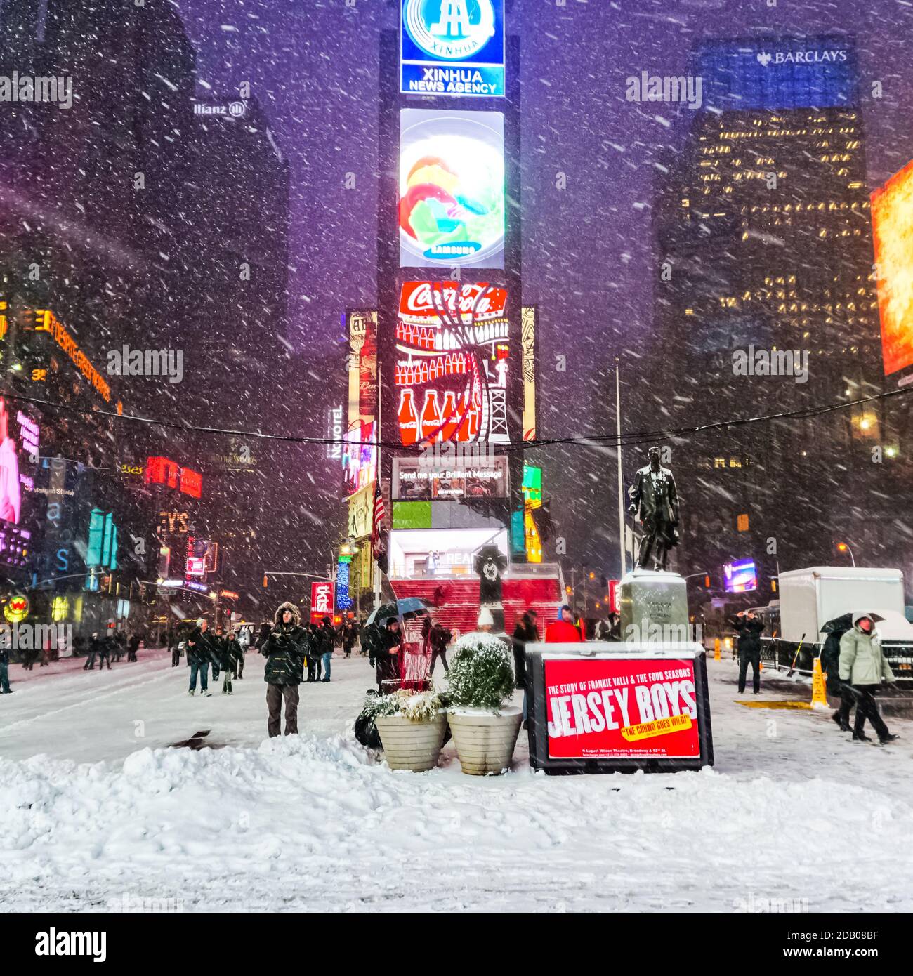 Times Square in winter blizzard snowstorm with people commuting and cars  and taxis on the New York City streets Stock Photo - Alamy