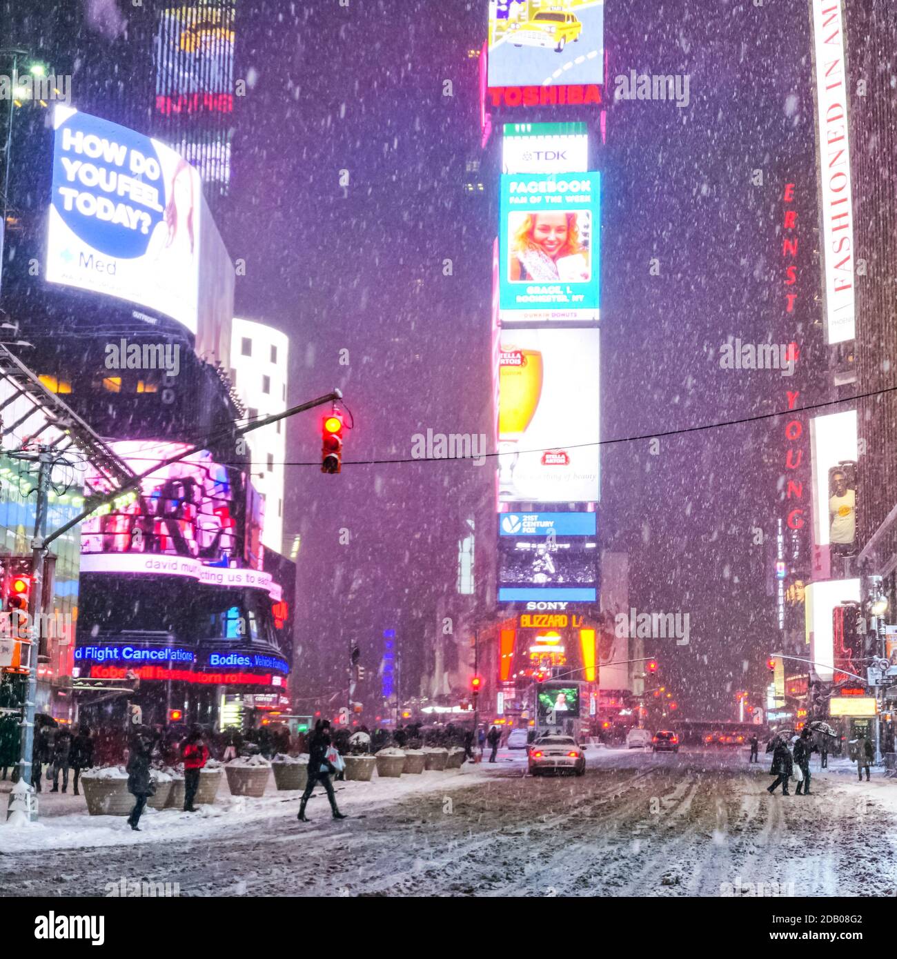 Times Square in winter blizzard snowstorm with people commuting and ...