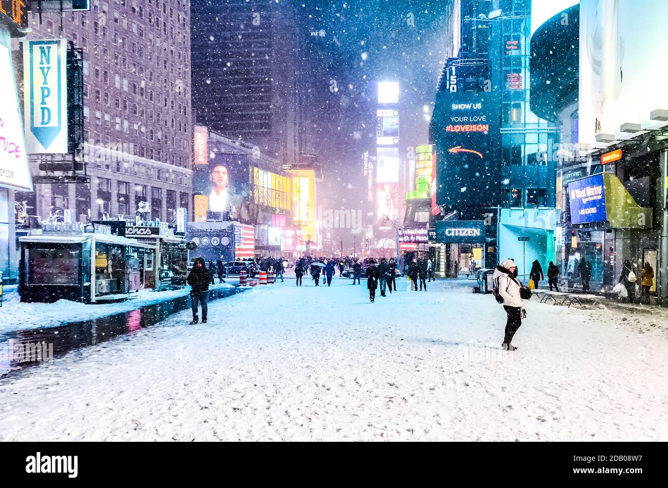 Times Square in winter blizzard snowstorm with people commuting and ...