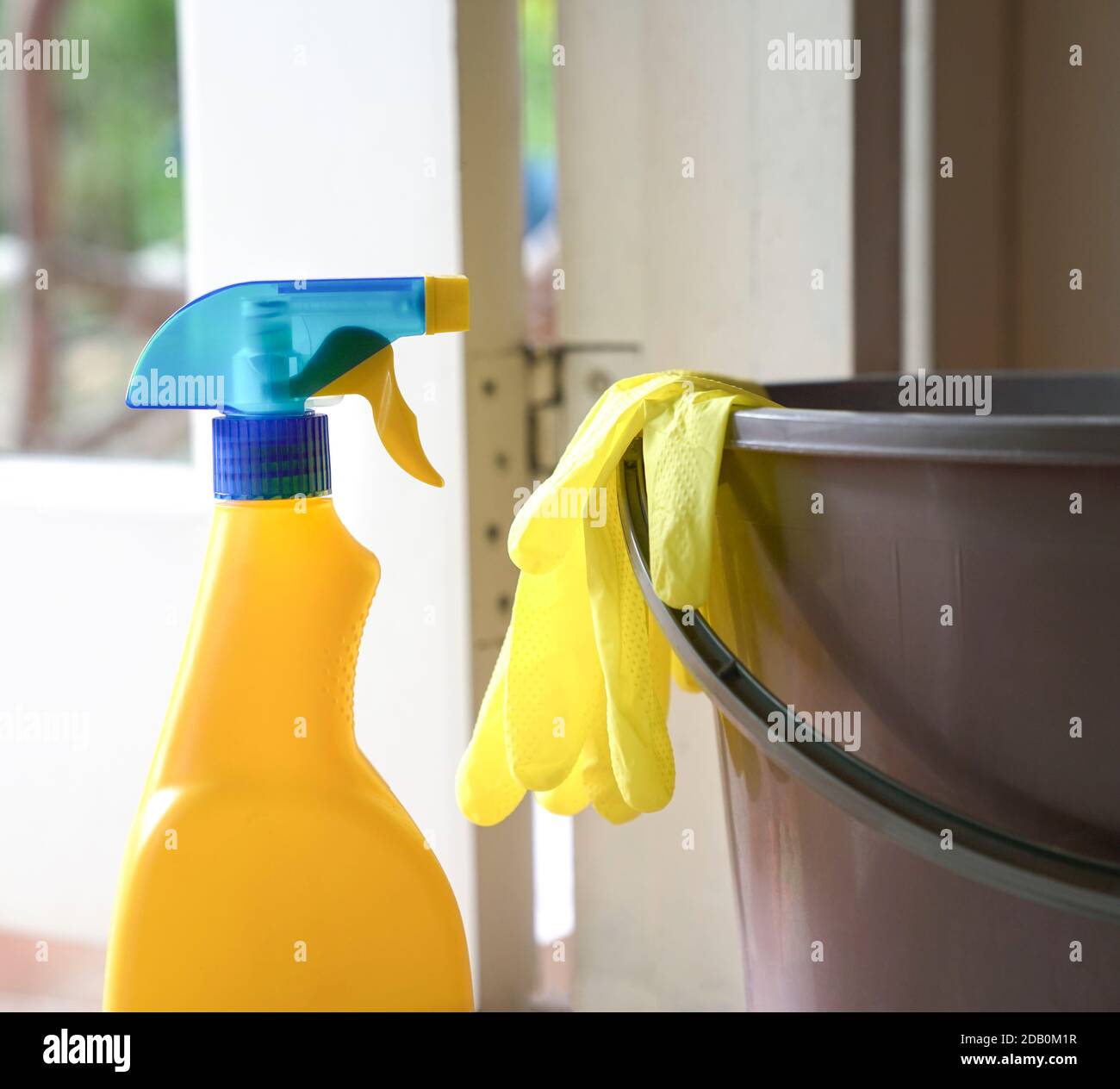 Cleaning spray gun with hand gloves and water pail. Tools for cleaning