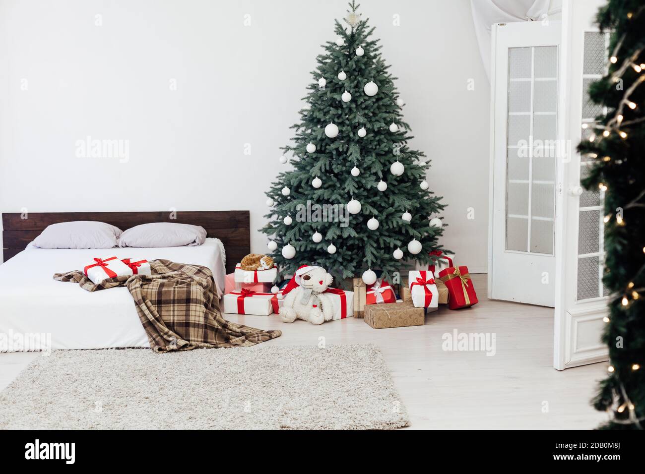 New Year's card bedroom interior with red bed decor and Christmas tree ...