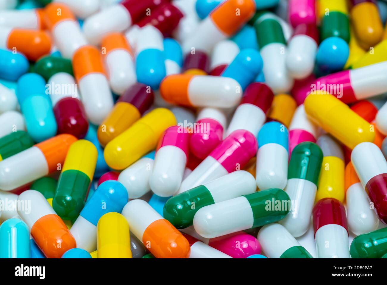 Selective focus on antibiotic capsule pills. Antibiotic drug resistance. Pile of bright colors capsule pills. Pharmaceutical industry. Pharmaceutical Stock Photo