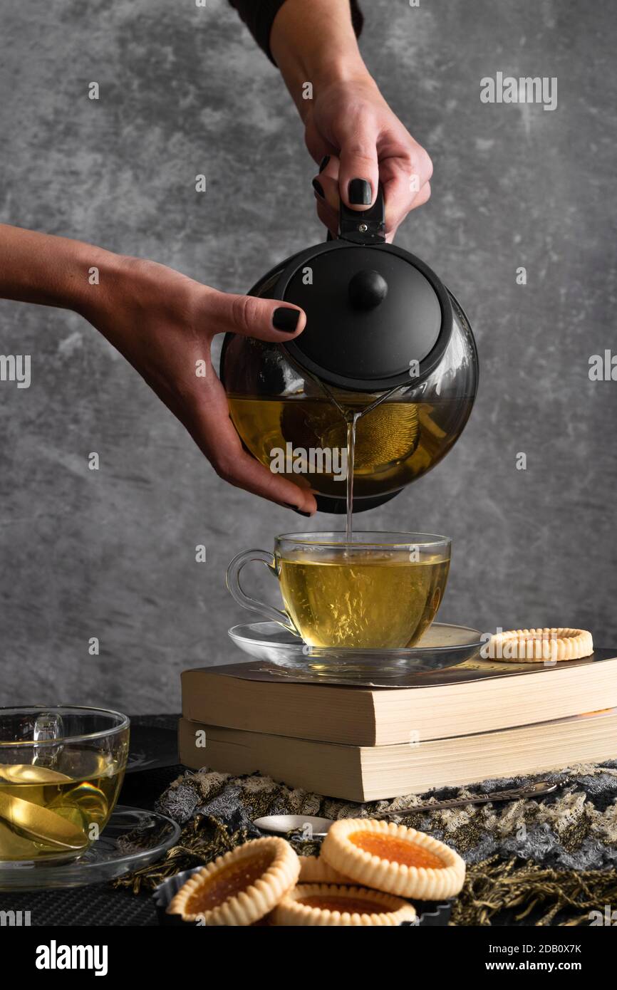 Woman hands pouring tea from a teapot Stock Photo Alamy