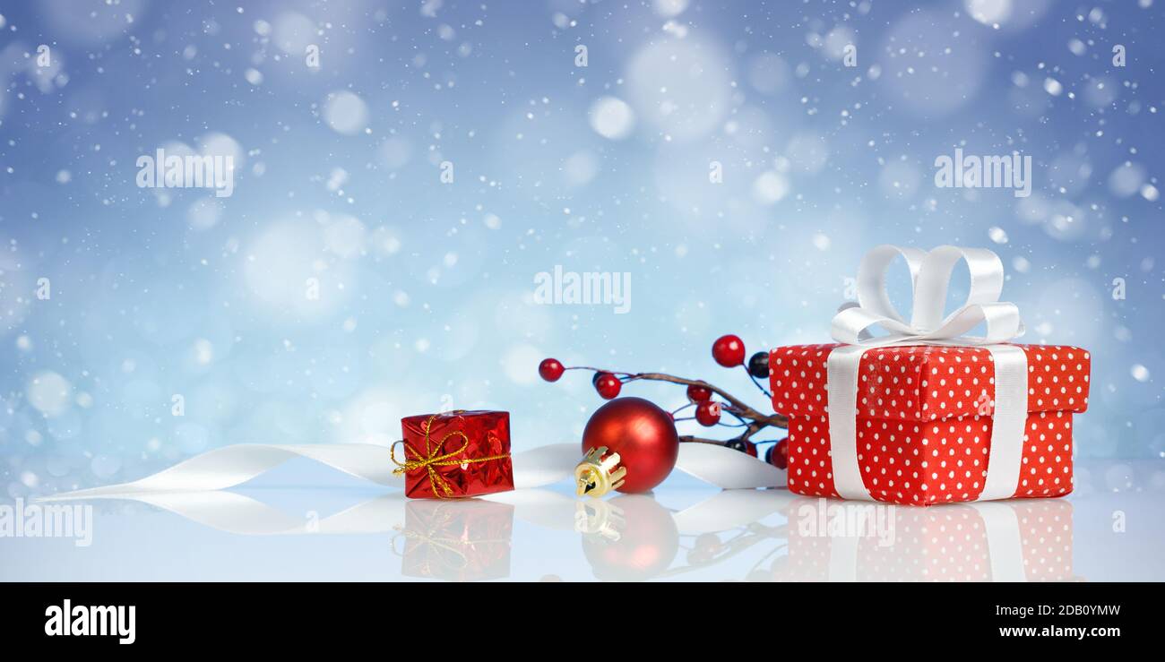 Red christmas gift box with decorations on blue background Stock Photo