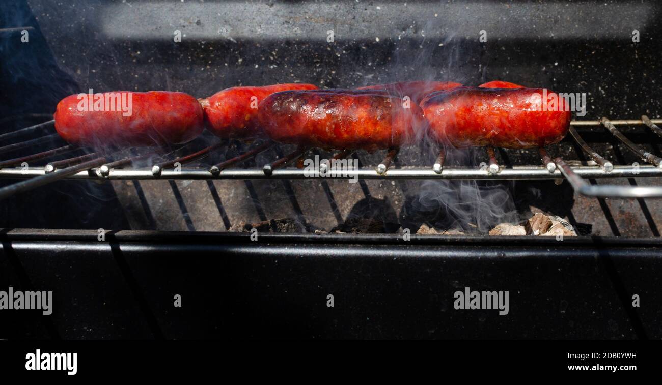 Barbecue of pork sausages on grill Stock Photo Alamy