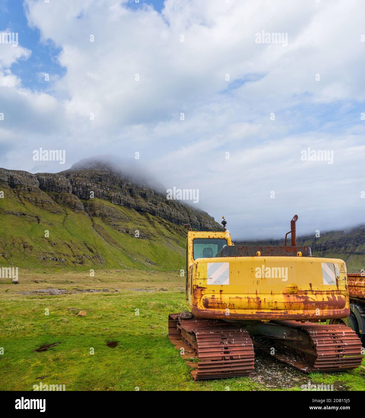 Old ruined excavator abandoned near the mountains Stock Photo