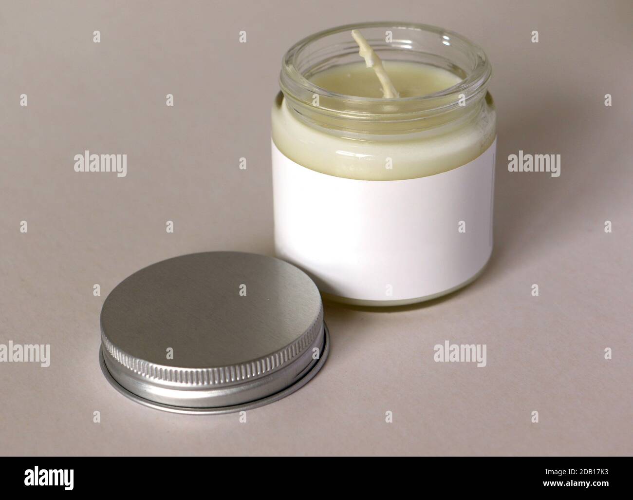 Glass jar with blank white label containing candle or creme Stock Photo