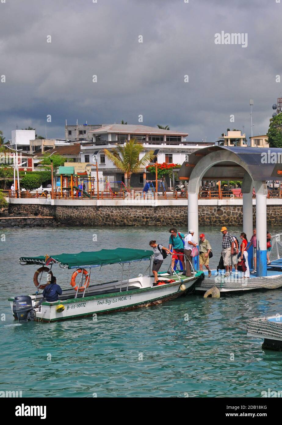 tourists boarding on a taxi boat at the jetty of harbour, Puerto Ayora, Santa Cruz island, Galapagos island, Ecuador Stock Photo