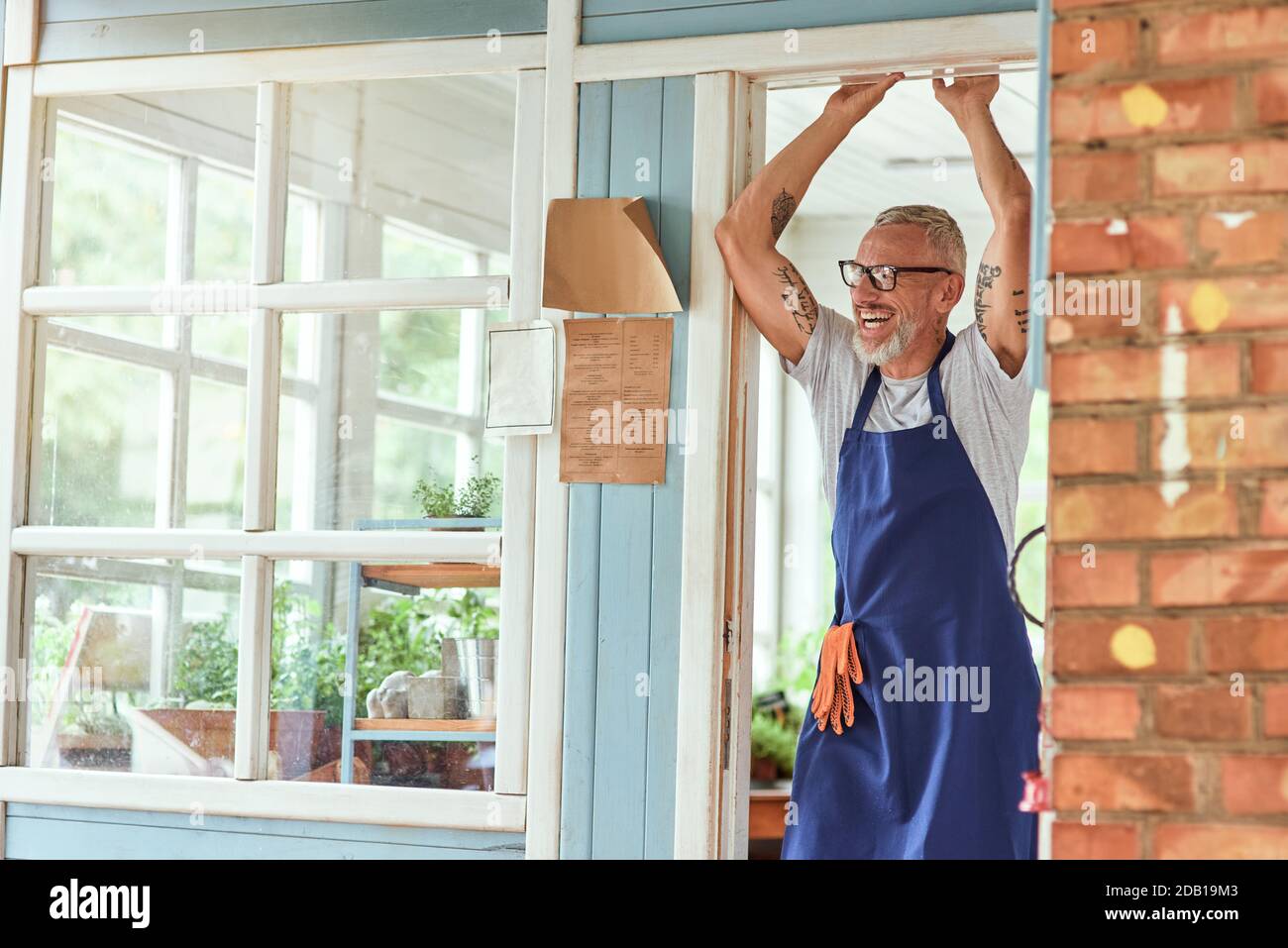 Middle aged caucasian man standing with raised hands Stock Photo