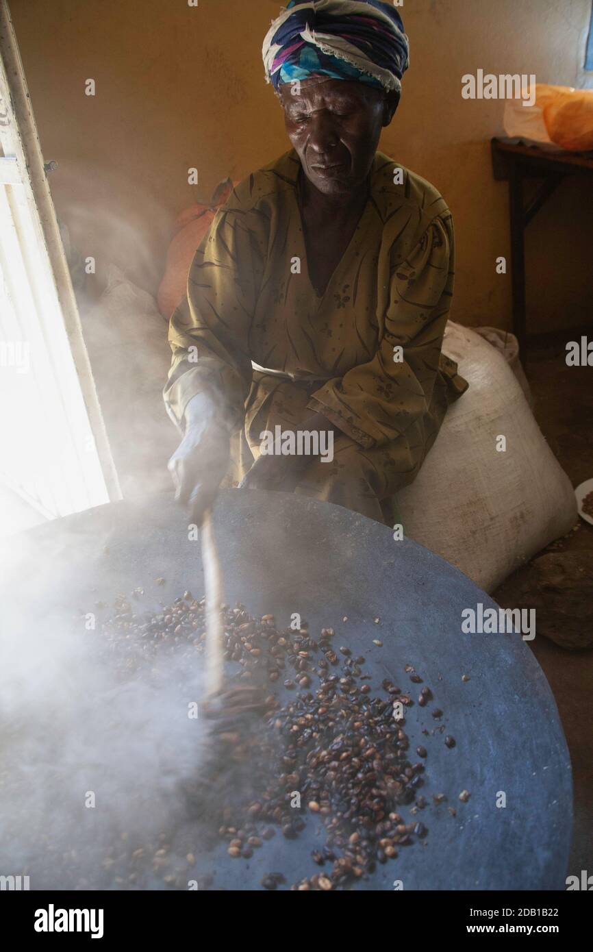 Ethiopian woman roasting coffee beans hires stock photography and