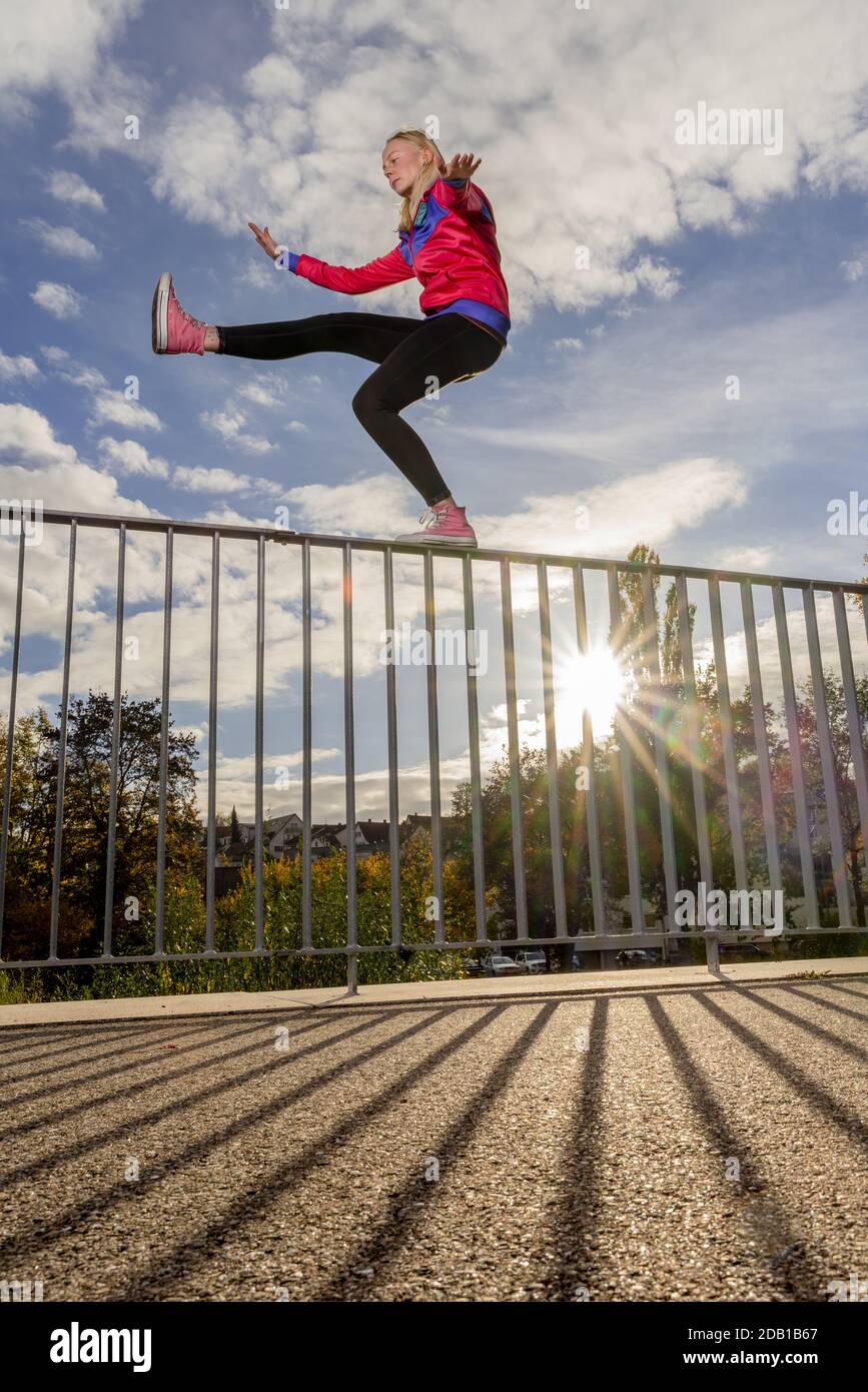 Balancing On Railing young woman balancing on a handrail, urban scenery in autumn Stock ...