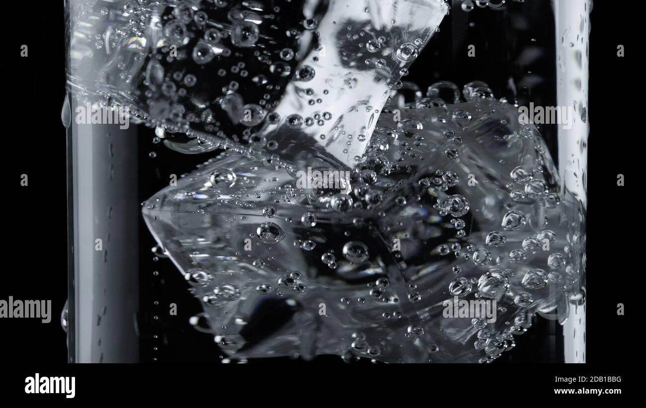 ice cube in fizzy splashing water with soda bubble Stock Photo - Alamy