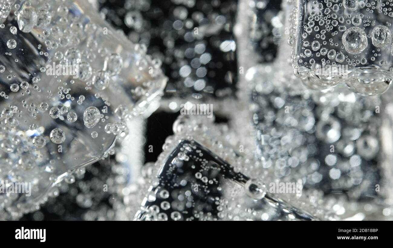 ice cube in fizzy splashing water with soda bubble Stock Photo - Alamy