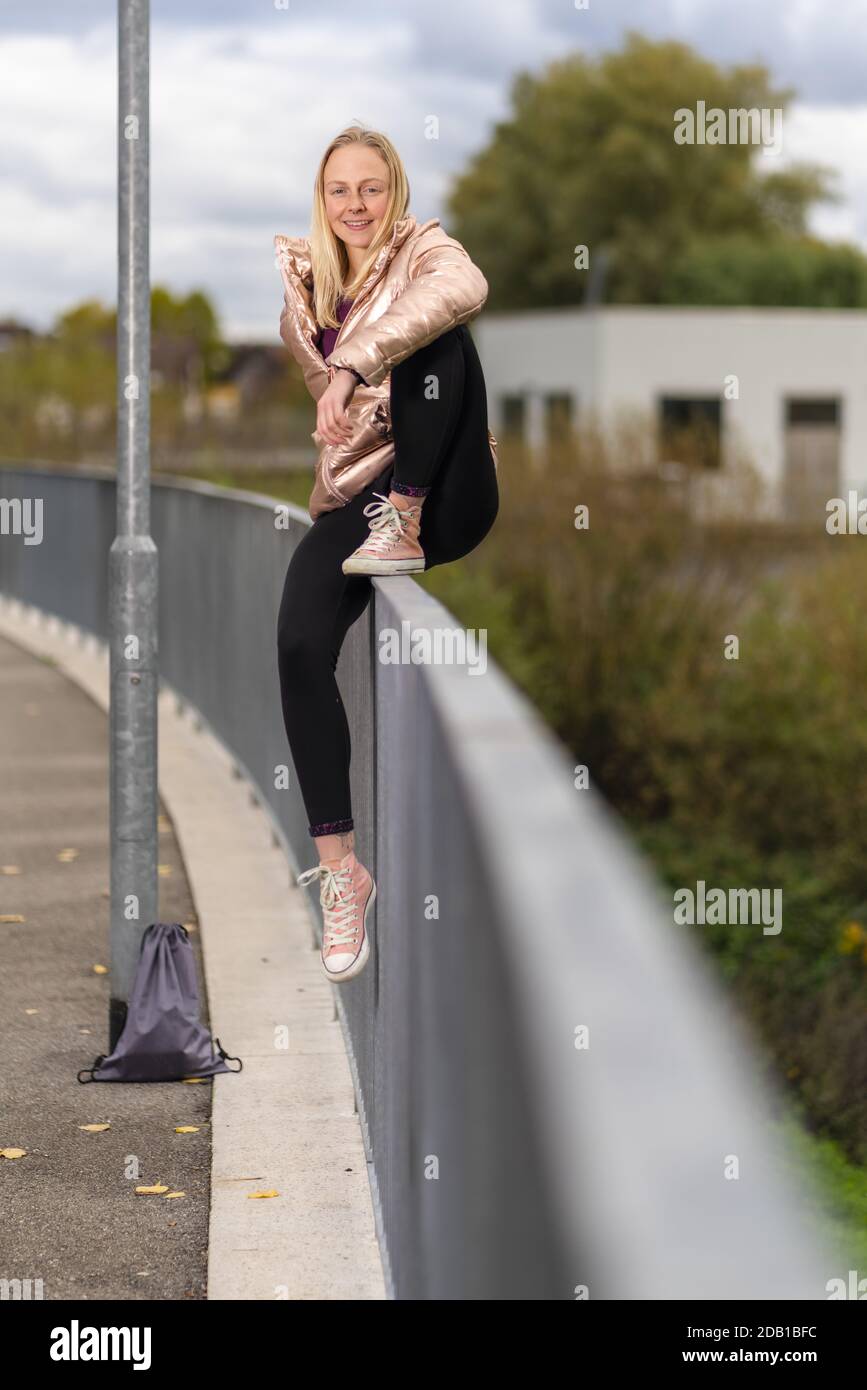Woman Using Handrail young women in healthy lifestyle outdoors, sitting on a handrail Stock ...