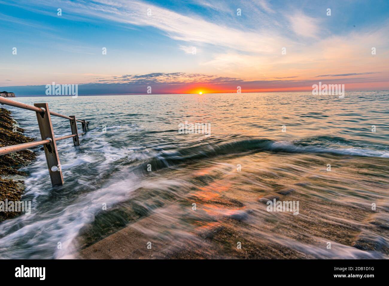 Summer Sunrise At Broadstairs With The Waves Swirling Around Peaceful And Calm Stock Photo