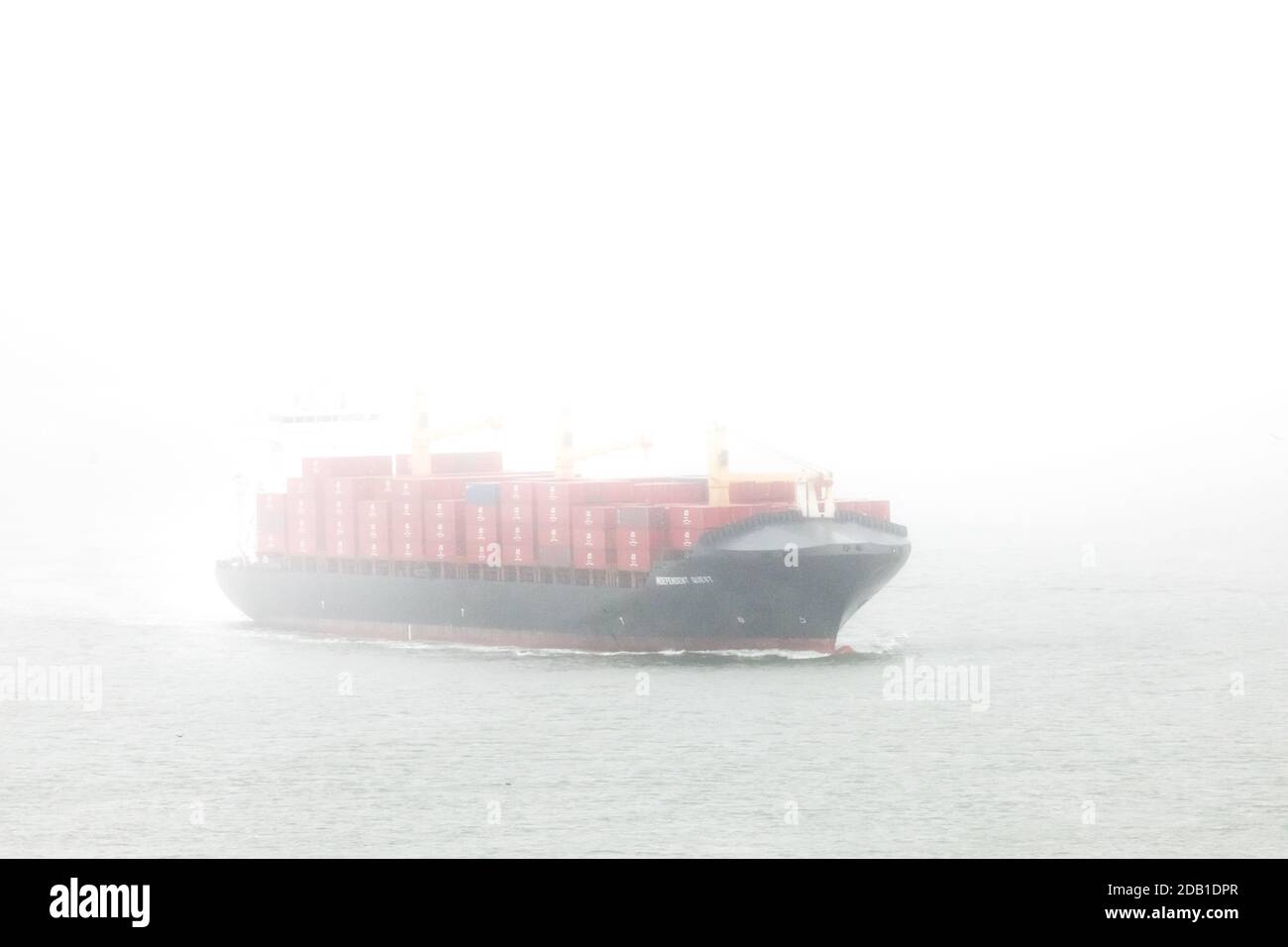 Cork Harbour, Cork, Ireland. 16th November, 2020. Container ship Independent Quest makes her way through Cork Harbour in heavy mist and fog as she departs with exports destined for Chester, Pennsylvania.  - Credit; David Creedon / Alamy Live News Stock Photo