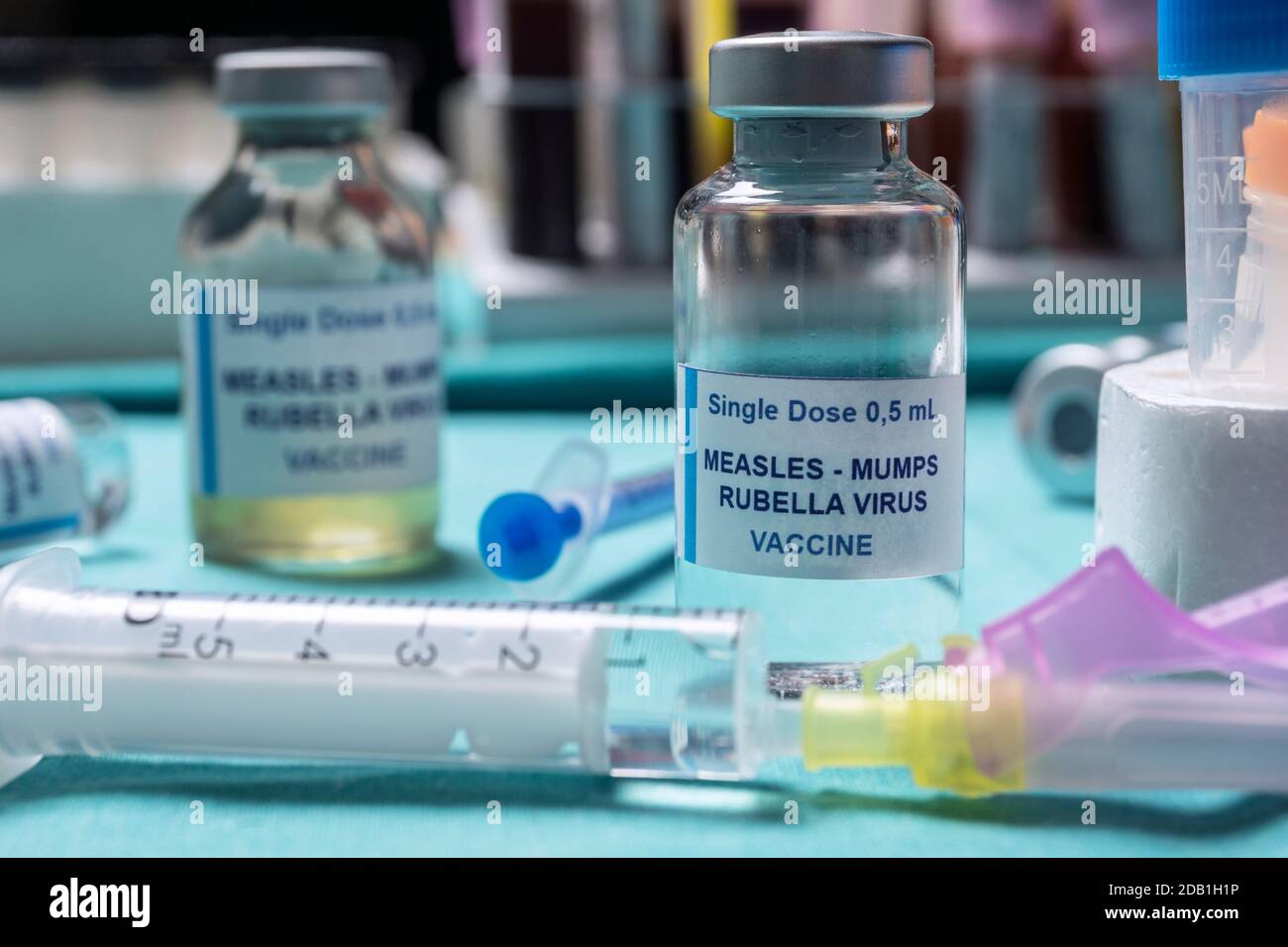 Different vials of triple viral vaccine of measles, rubella and mumps, known as MMR, conceptual image Stock Photo