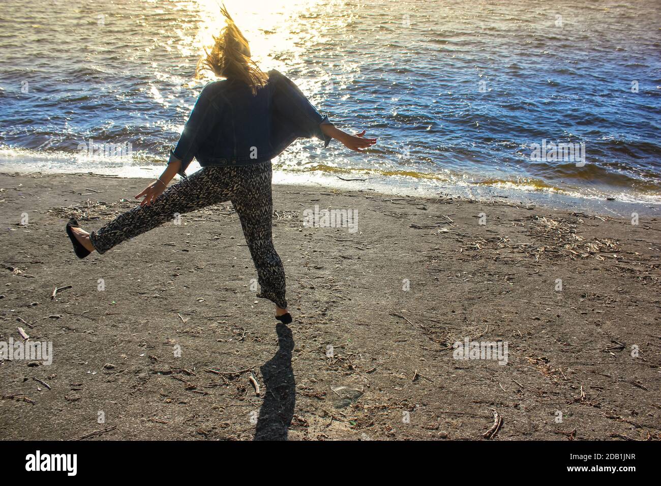 Woman dancing beach jeans hi-res stock photography and images - Alamy