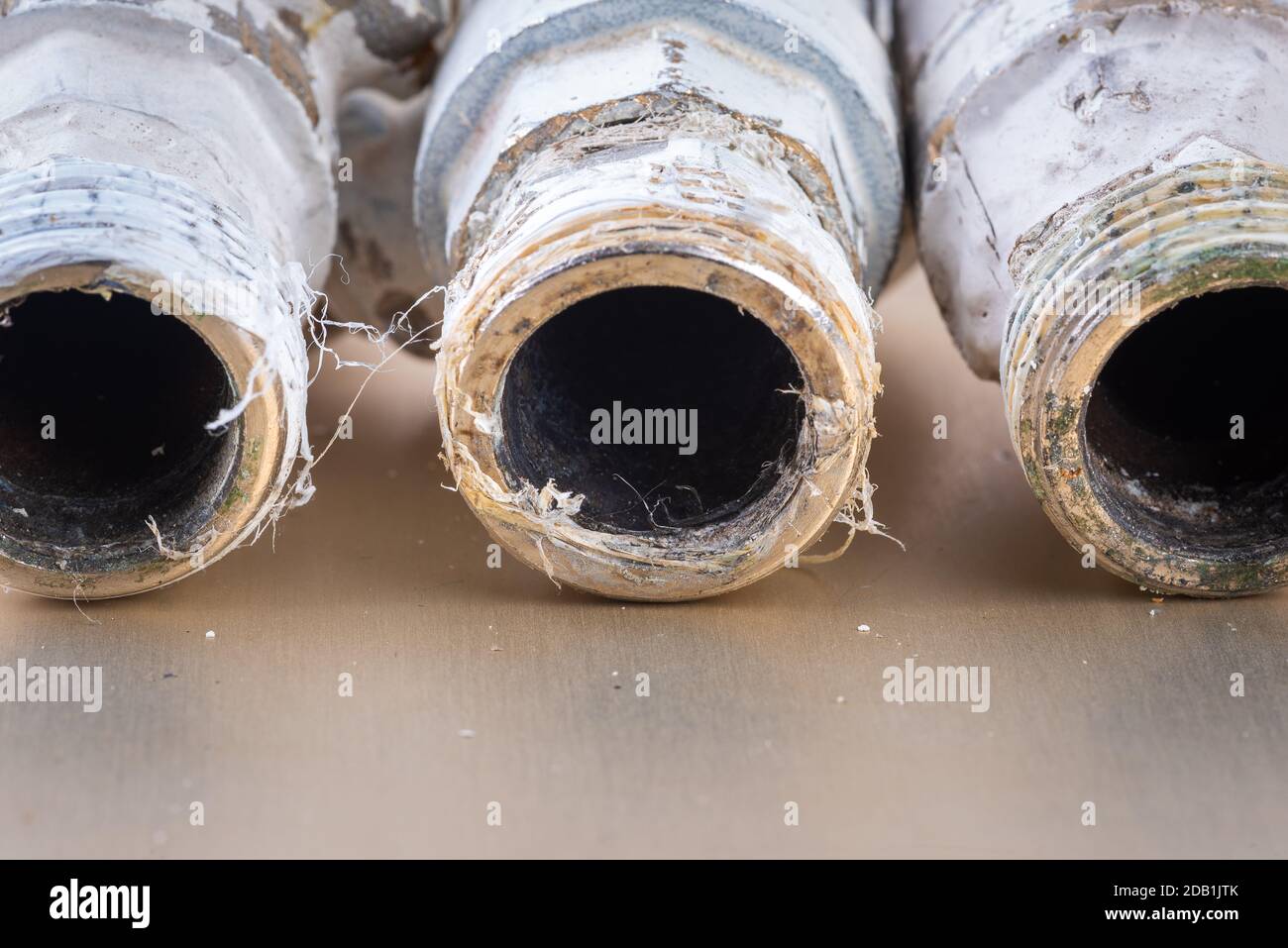 Old used plumbing fittings for water pipe installation Stock Photo