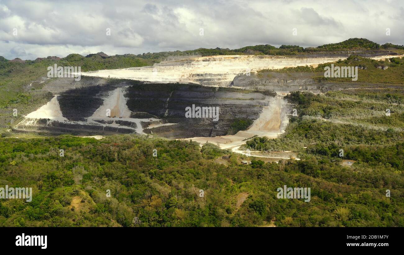 Open pit limestone quarry in the mountains of Bohol Island, Philippines