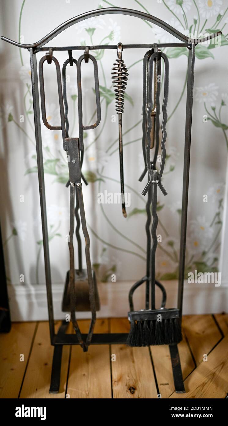 tools for fireplace hanging on stand indoors Stock Photo
