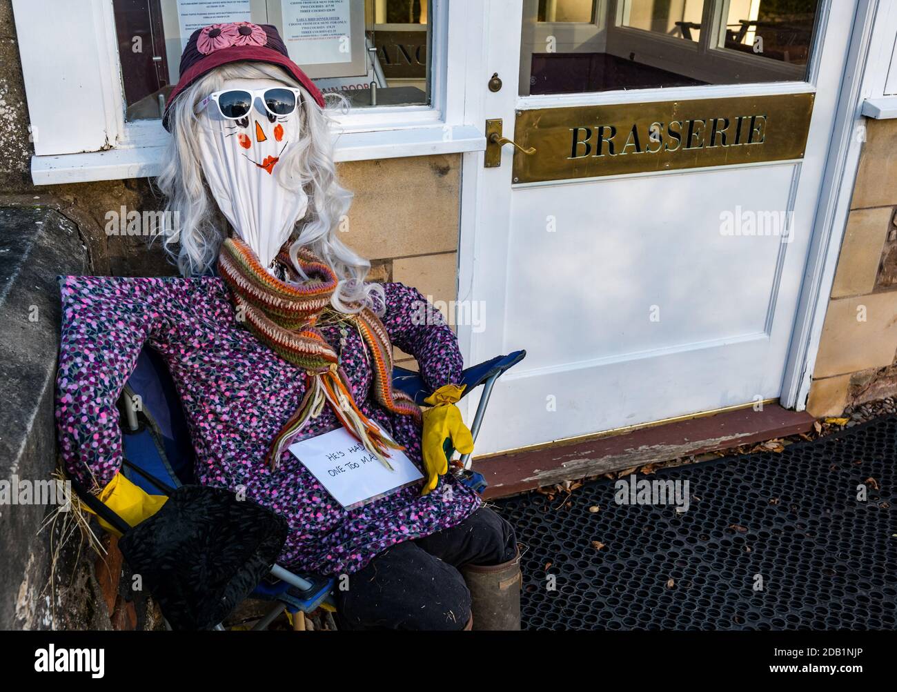 Dirleton, East Lothian, Scotland, UK, Dirleton Village scarecrow competition:  the first project of the village Good Neighbours’ “Reasons to be Cheerful” project encourages residents of all ages to create a scarecrow. The project is funded by a grant from North Berwick Coastal Area Partnership. The aim is bring some fun to this challenging time. A scarecrow at the Open Arms hotel and brasserie Stock Photo