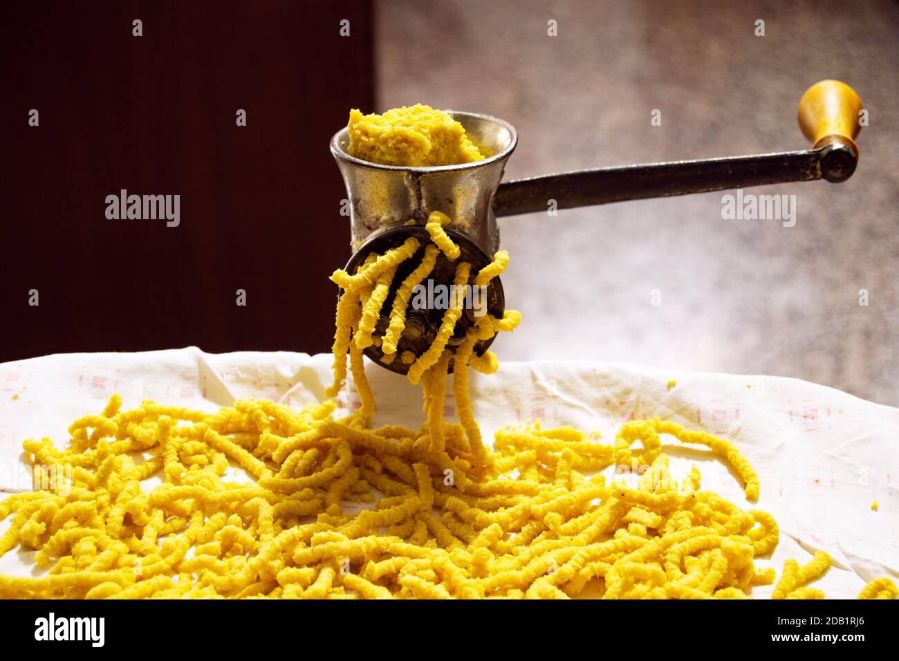 Making passatelli traditional italian pasta of Modena. concept for food and cooking, hobby during coronavirus lockdown Stock Photo