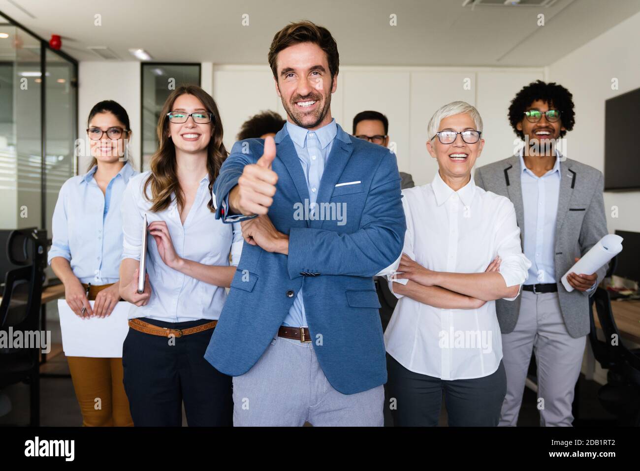 Happy business people celebrating success at company Stock Photo - Alamy