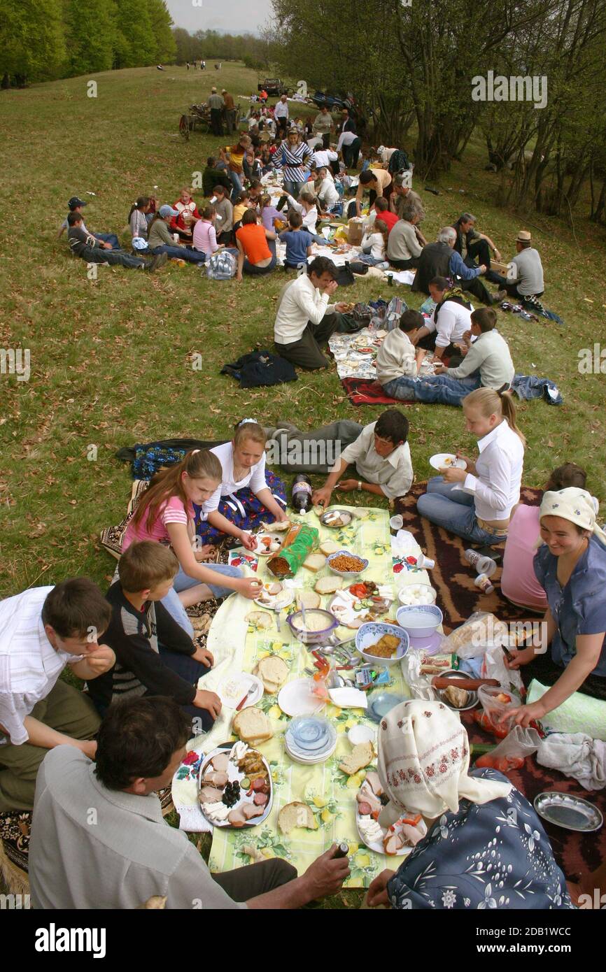 Maramures, Romania. Spring event when the sheepfold is organized before heading to the mountain pastures. Villagers sharing a meal outdoors. Stock Photo