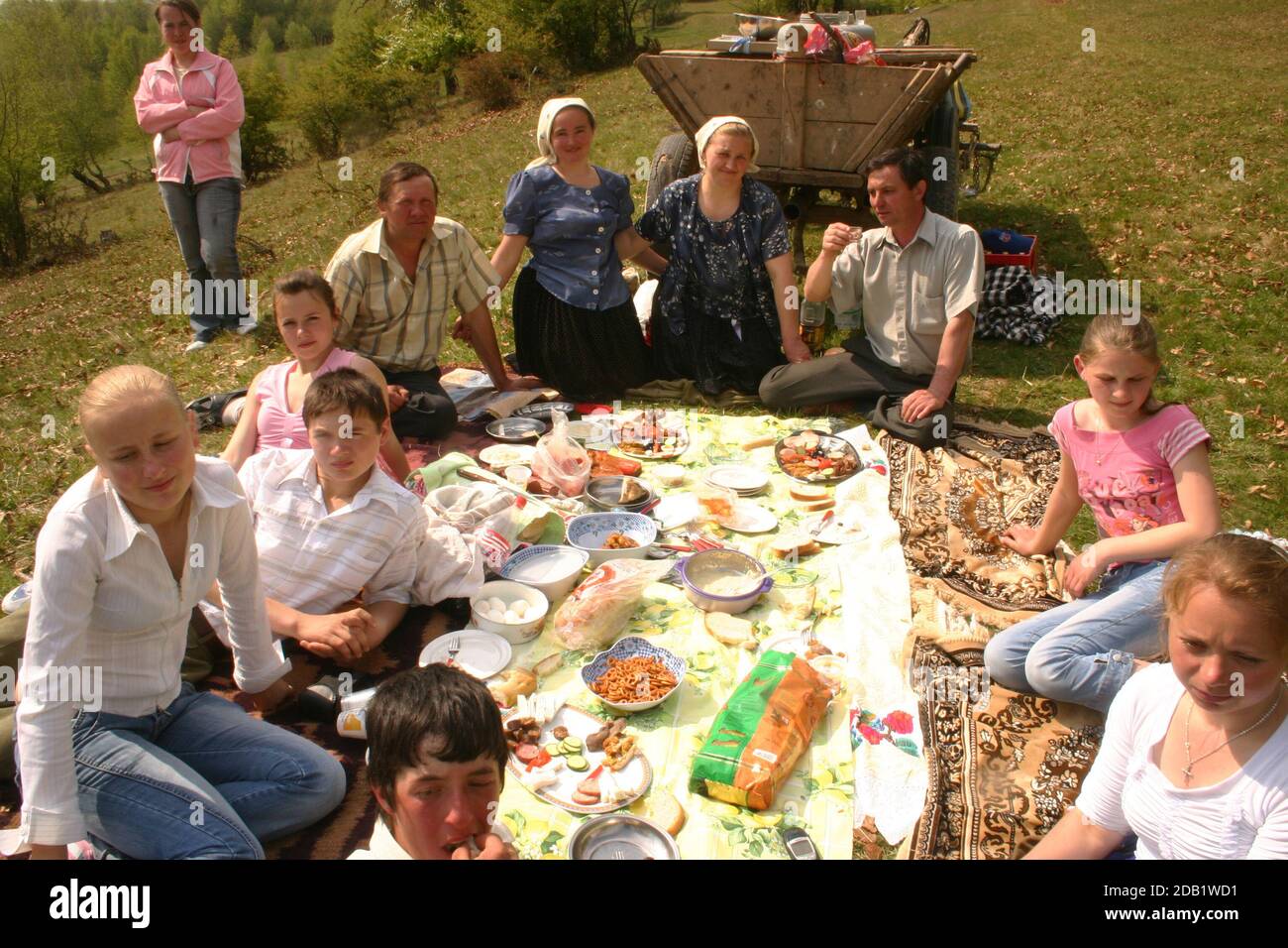 Maramures, Romania. Spring event when the sheepfold is organized before heading to the mountain pastures. Villagers sharing a meal outdoors. Stock Photo