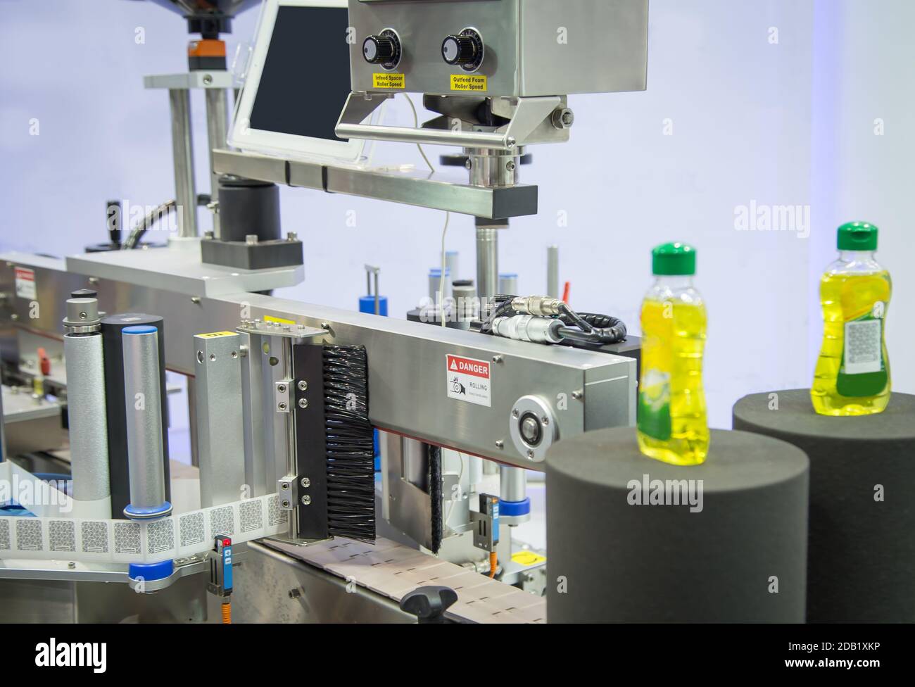 Sample products on bottle labeling machine in industrial machinery Stock Photo