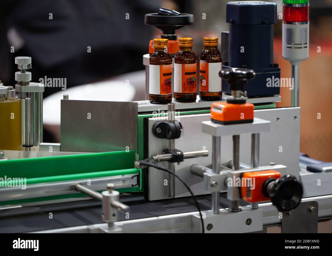 Bottle of food product on bottle labeling machine. Pharmaceutical industry Stock Photo