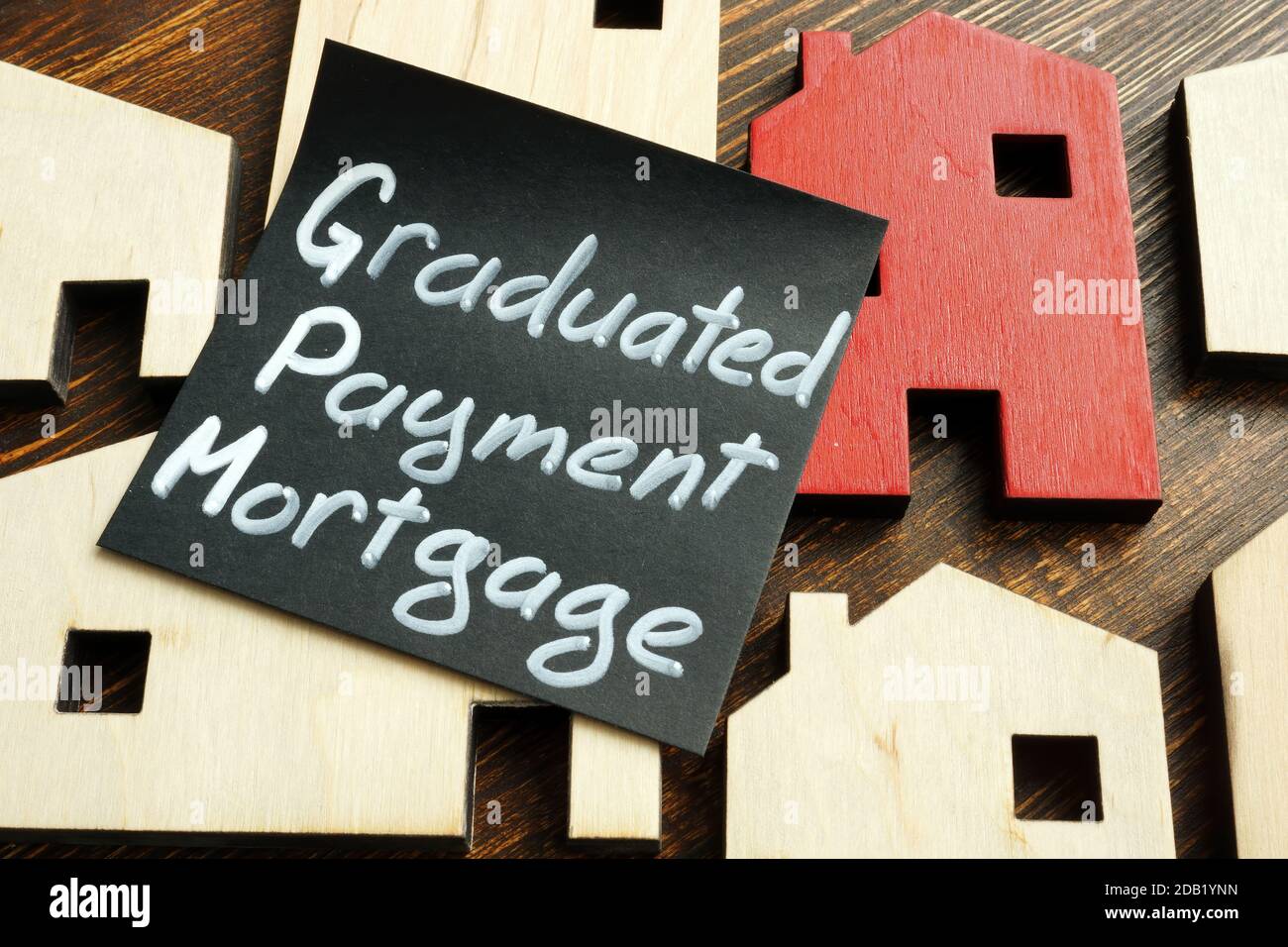 Graduated payment mortgage GPM sign and tiny houses. Stock Photo