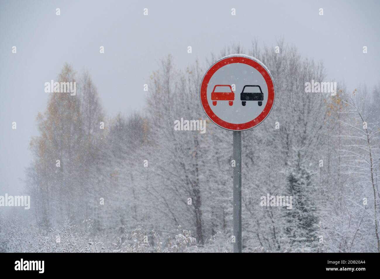 No overtaking sign on the winter road Stock Photo