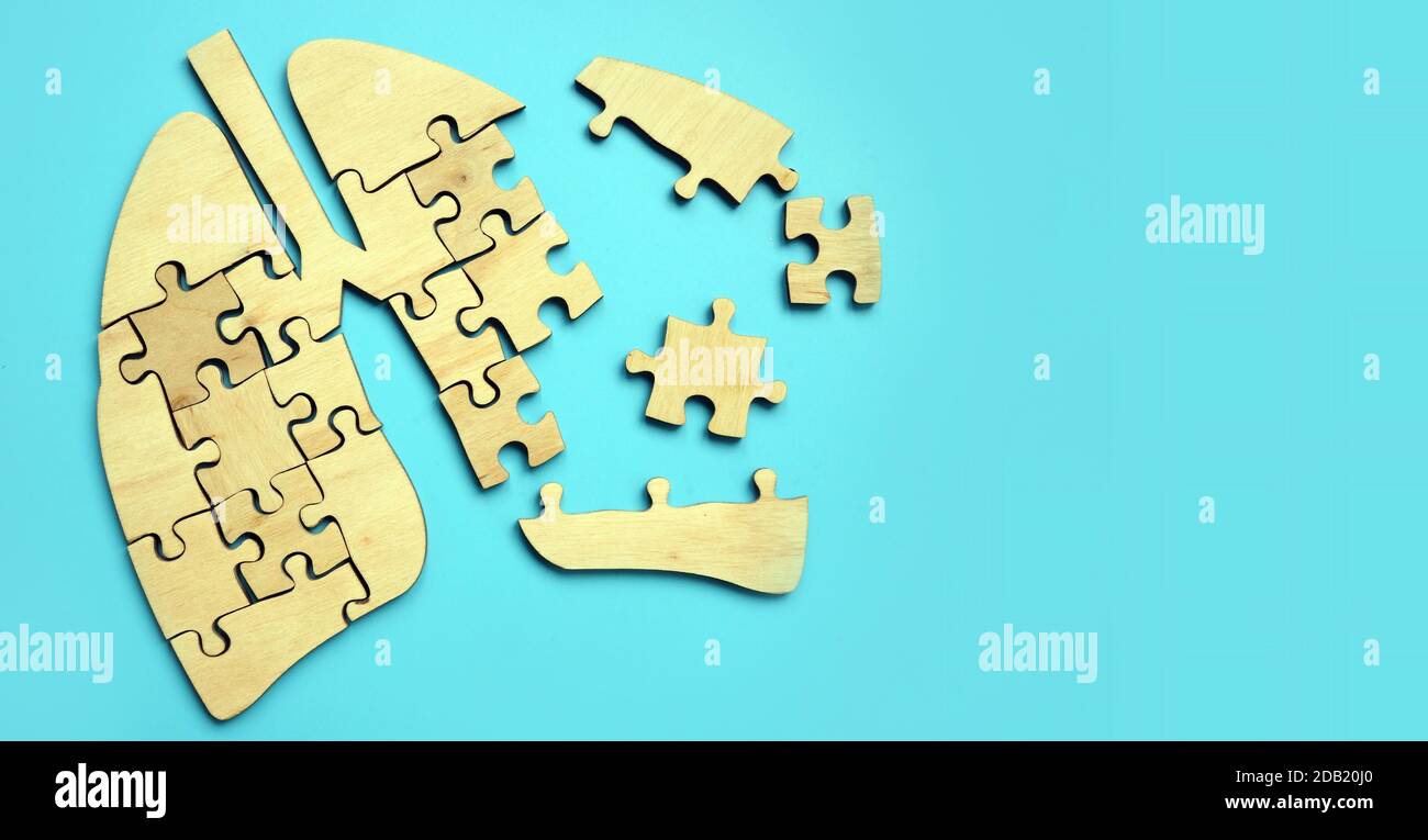 Damaged lungs from puzzle pieces. Respiratory tract disease. Stock Photo