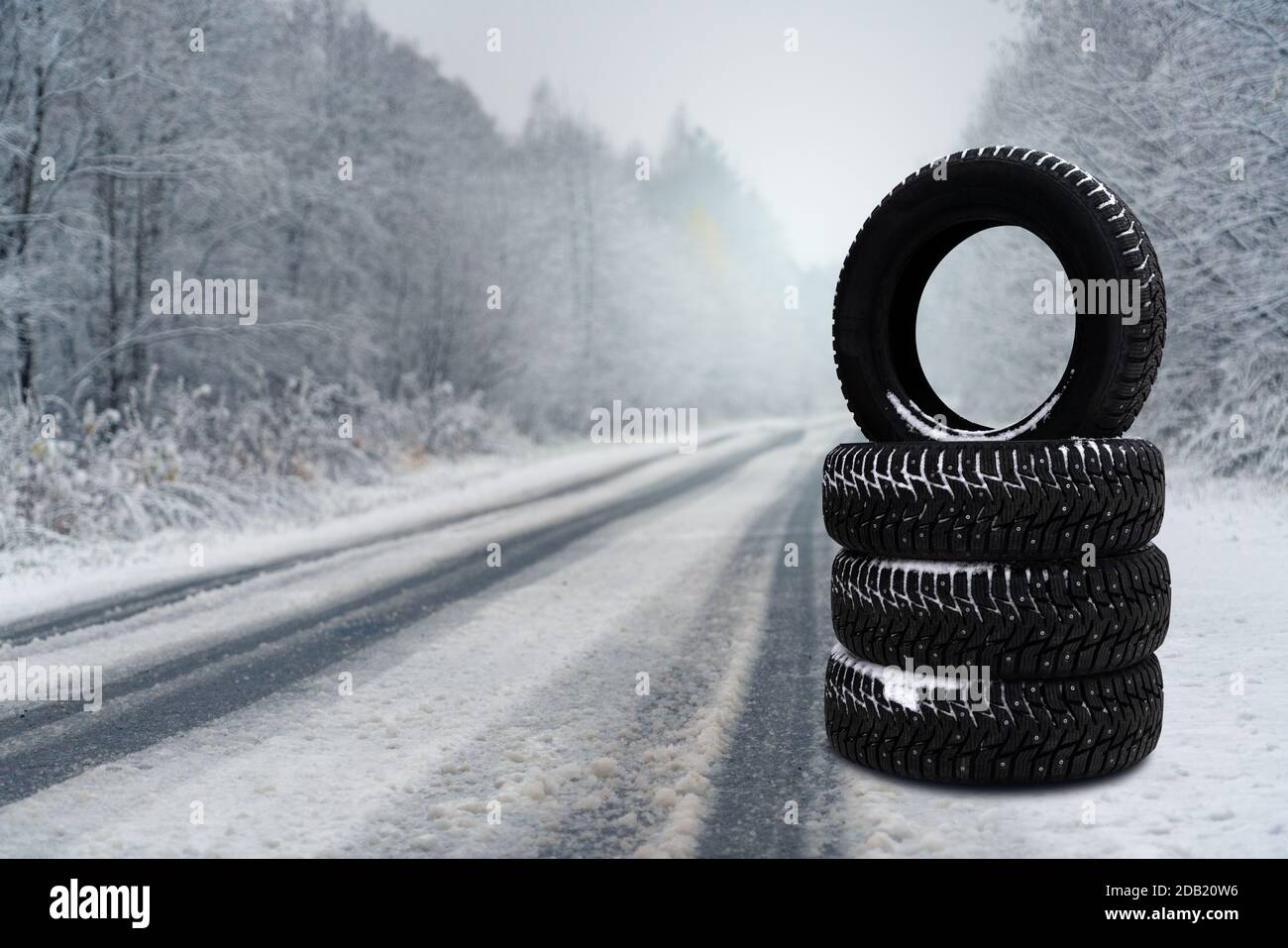 Winter tires on a snowy road. Seasonal tire change.  Stock Photo