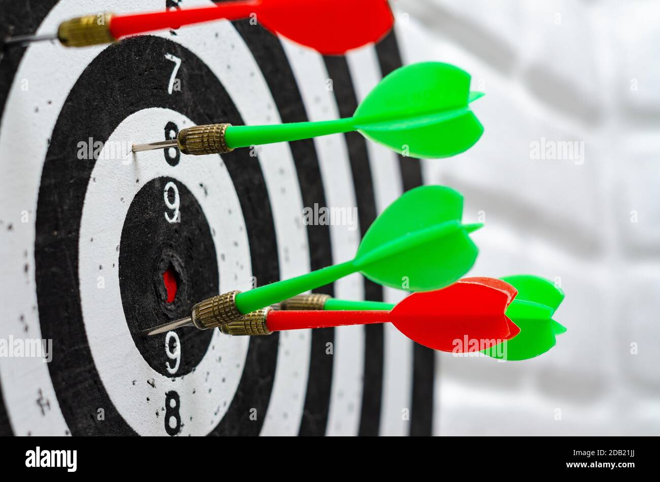 Darts stick out in round target in dartgame game Stock Photo - Alamy