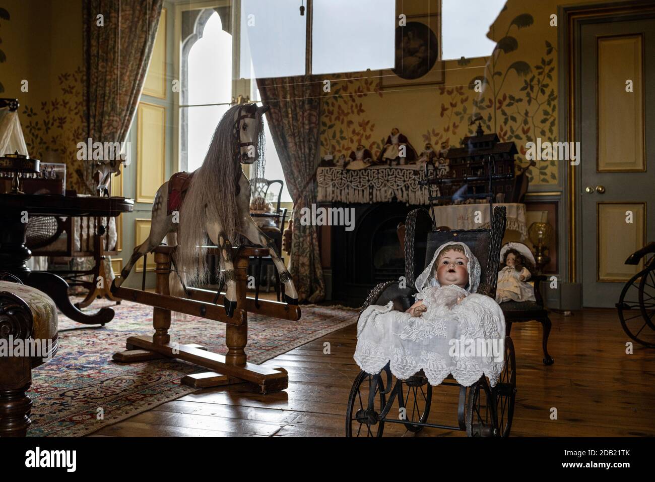 Victorian nursery with dolls, rocking horse, pram, and childrens furniture in Kilkenny castle, County Kilkenny, Ireland Stock Photo