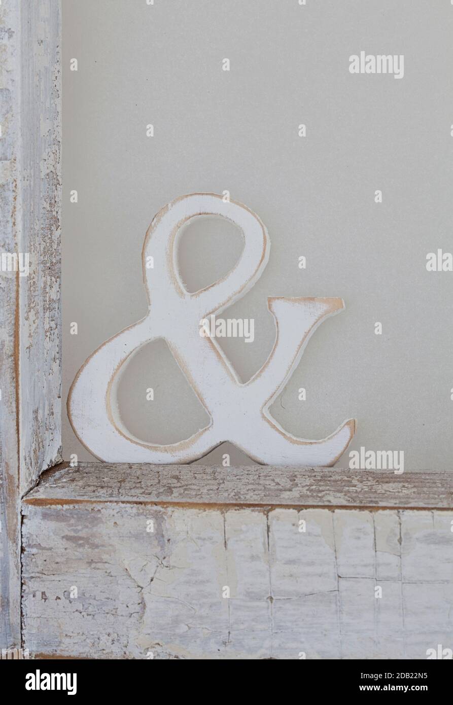 https://c8.alamy.com/comp/2DB22N5/wooden-ampersand-symbol-in-an-old-white-frame-2DB22N5.jpg