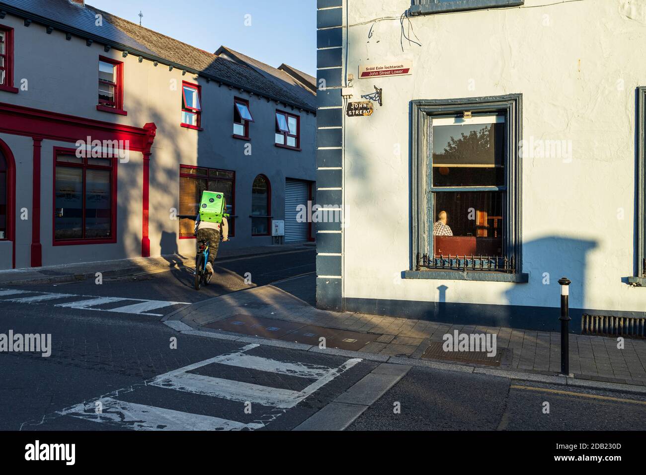 Food delivery cyclist on John street outside Brogans public house in Kilkenny, County Kilkenny