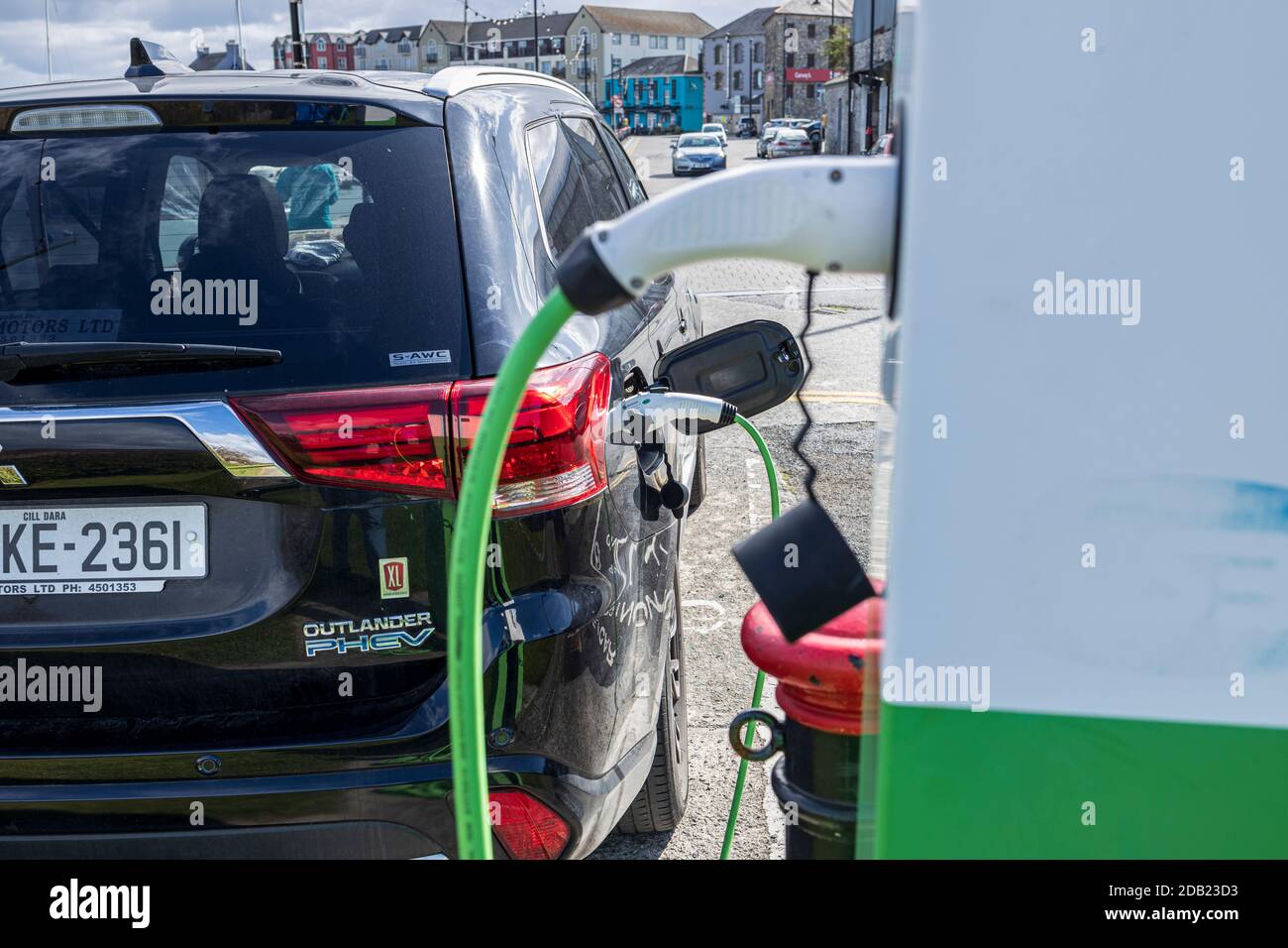 E vehicle, electric car charging point plugged in to a Mitsubishi Outlander PHEV electric SUV, Dungarvan, County Waterford, Ireland, Stock Photo