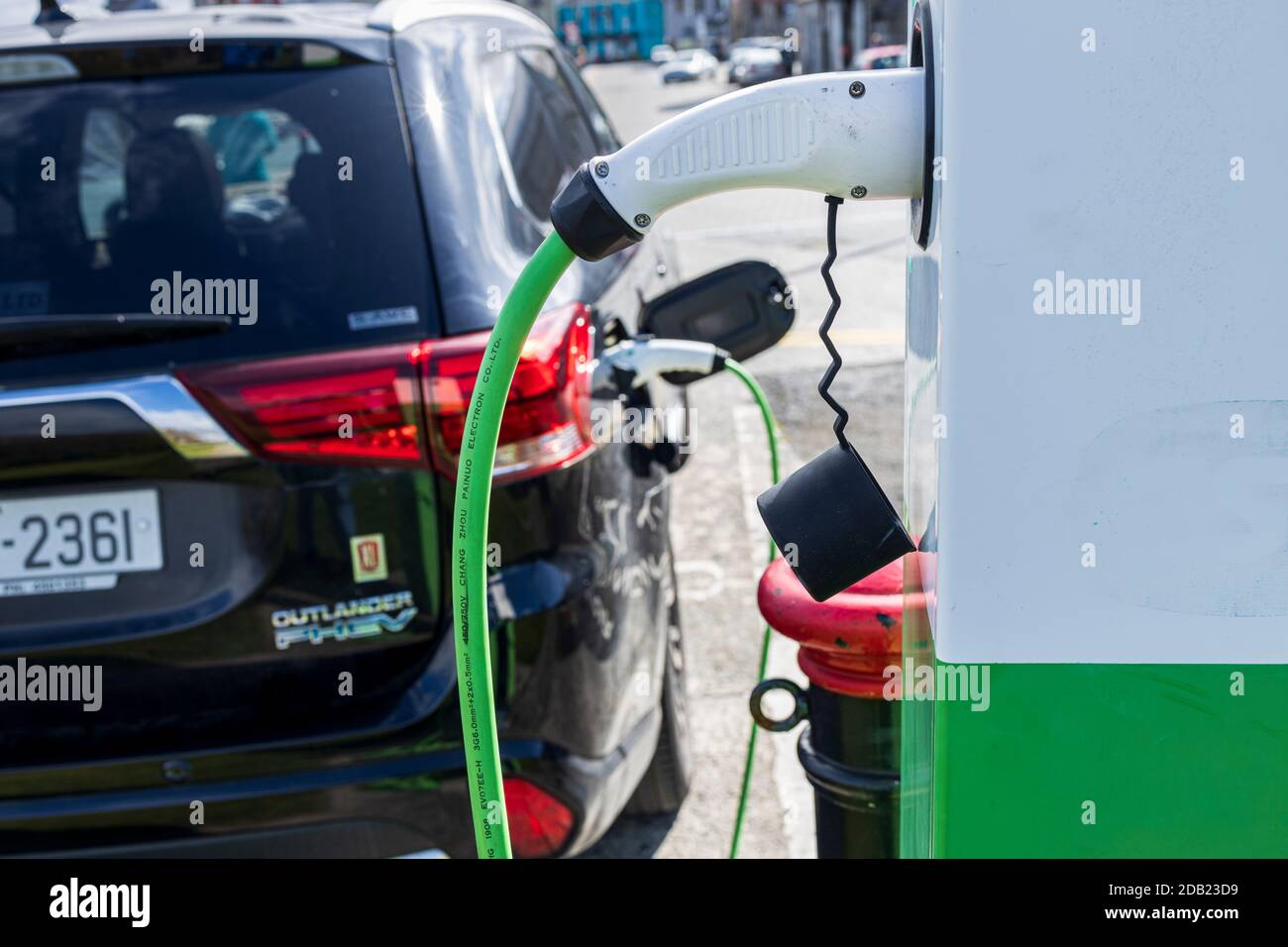 E vehicle, electric car charging point plugged in to a Mitsubishi Outlander PHEV electric SUV, Dungarvan, County Waterford, Ireland, Stock Photo